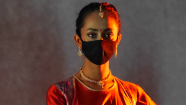 Woman in traditional Indian dress, wearing mask