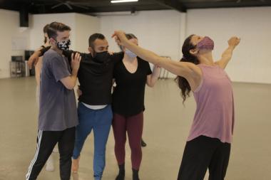 In-studio rehearsal photo of sjDANCEco Co-Artistic Director Maria Basile (in pink shirt) demonstrating movement from Yield to her dancers. Dancers (left to right) are: Ryan Tucker, Kevin Gaytan and Kyleigh Carlson.   Photo by Tom Hassing courtesy of sjDANCEco.