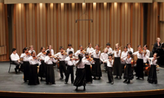 The Colburn Community School Suzuki students performing on stage.