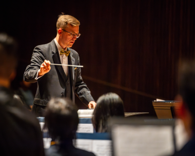 Dr. Matthew Sadowski conducting the UC Berkeley Wind Ensemble in Hertz Hall