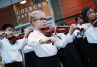 Young Colburn School students performing outside of the Colburn Cafe.