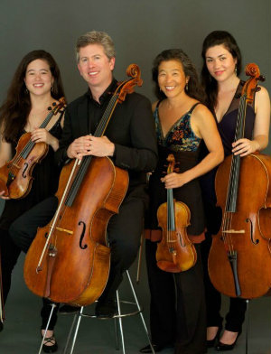 "(Almost) All in the Family": husband and wife cellist Peter Wyrick and violinist Amy Hiraga have their cellist daughter Mariko Hiraga Wyrick (right) in the orchestra with them on the tour; violinist daughter Mayumi Hiraga Wyrick (left) would make it a quartet-within-orchestra